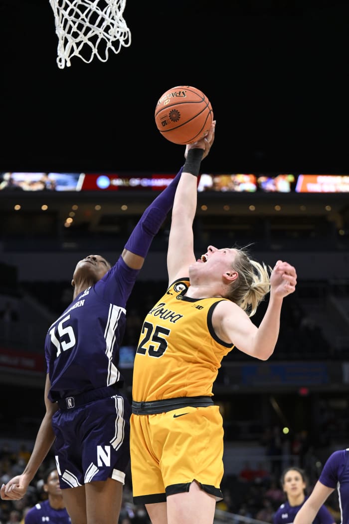 Northwestern's Courtney Shaw gets a big block off of Iowa's Monica Czinano in Big Ten quarterfinal game at Gainbridge Fieldhouse. Photo courtesy of Northwestern Women's Basketball.
